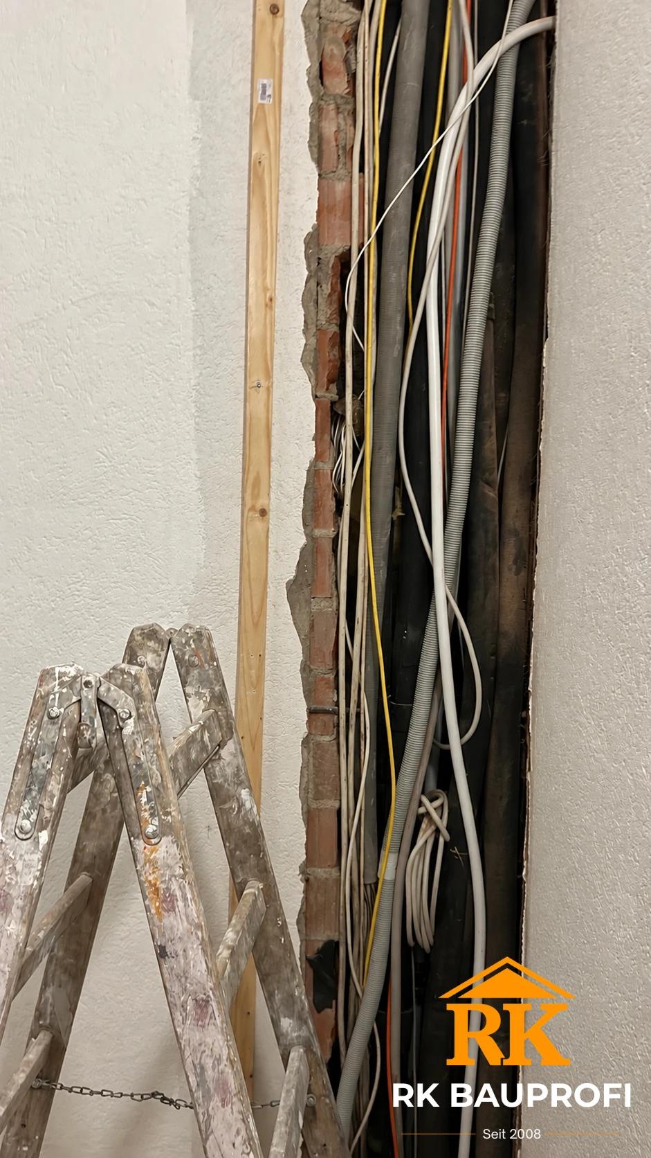 Wandpaneel Bürstadt Vorher – geöffnete Wand mit offen liegenden Kabeln und Installationsrohren